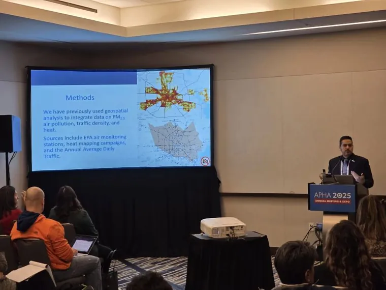 Dr. Aguilera presenting a GIS exposure map at the APHA 2025 annual meeting.