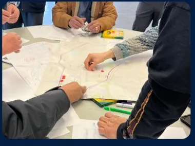 Community members marking pollution and traffic concerns on a neighborhood exposure map.