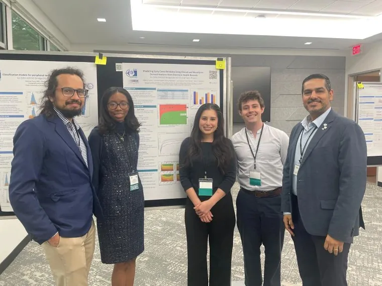 The AIM-AHEAD Bridge2AI project team beside their research poster.